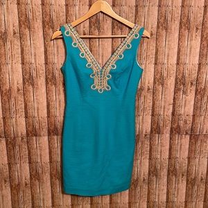 Lilly Pulitzer teal dress with gold accents.